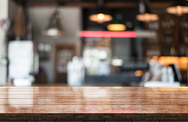Empty wooden table top with lights bokeh on blur restaurant background