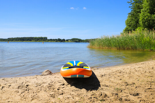 A stand up paddle board on the beach from Silz on Fleesen lake (Fleesensee), Mecklenburg Lake Plateau, Germany