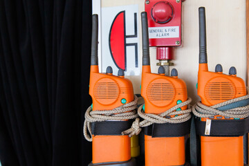 Three orange emergency radios on a ship near an alarm. Apply in case of general or fire alarm. © Сергей Жмурчак