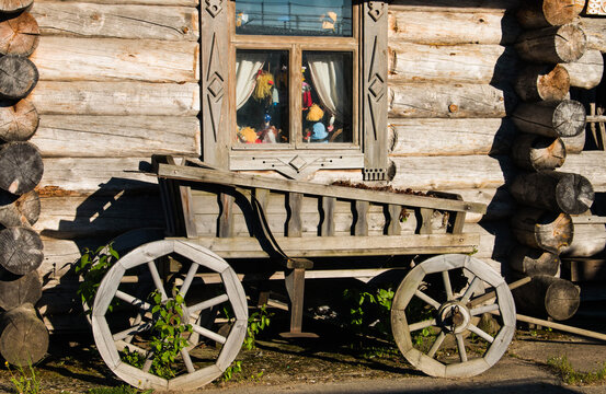 Old wooden farm wagon with traditional wheels made of wood and an iron rim. A historical cart.