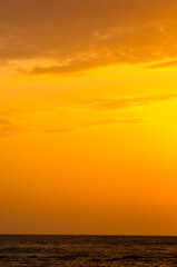 Amazing sea sunset on the pebble beach, the sun, waves, clouds