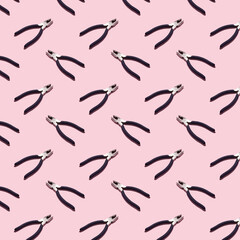 Pliers on a pink background, pattern, hard shadows. Construction tools, repairs. Background for the design.