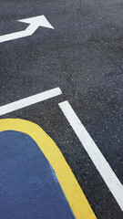 Directions and life decisions concept background. A close up photo shot in portrait mode with arrow road marks on the asphalt