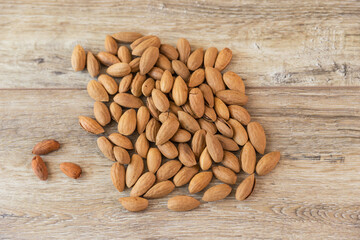 Almonds, almonds with shell on a wooden table background.