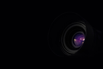 Close-up black camera lens with copy space on dark background