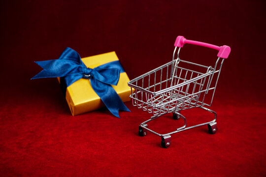 supermarket cart with soft focus gift camera background. 