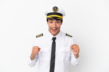Airplane pilot over isolated white background celebrating a victory in winner position