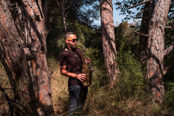 Saxophonist playing a saxophone solo in the woods