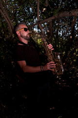 Saxophonist playing a saxophone solo in the woods