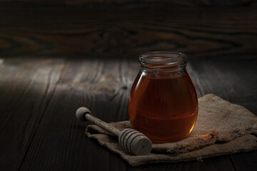 Honey background. Sweet honey in the comb, glass jar.