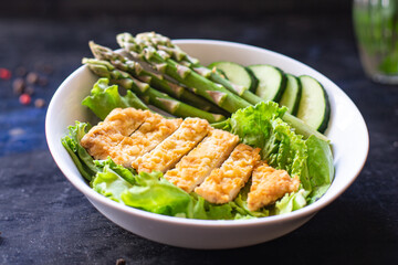 salad bowl chicken meat, asparagus, greens salad leaves vitamin eating organic diet on the table healthy food meal snack copy space food background rustic. top view keto or paleo diet veggie 