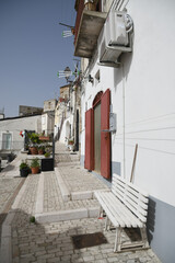 Candela, Italy, 06/21/2021. A small street between the old houses of a mediterranean village of Puglia region.