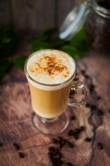  cup of cappuccino coffee with foam on rustic background