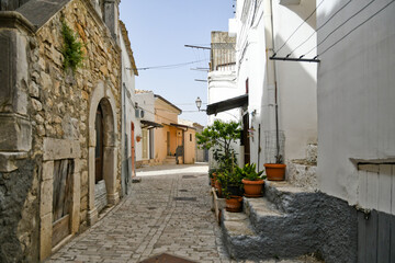 Candela, Italy, 06/21/2021. A small street between the old houses of a mediterranean village of Puglia region.