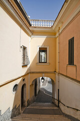 Candela, Italy, 06/21/2021. A small street between the old houses of a mediterranean village of Puglia region.