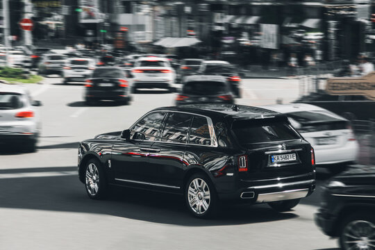 Kiev, Ukraine - May 22, 2021: Black luxury British Rolls Royce Cullinan SUV in motion. Rolls Royce Cullinan in the city