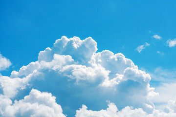 Naklejka na ściany i meble Fluffy, cumulus clouds against blue sky