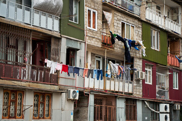 Fototapeta na wymiar Household traditions in Georgia. Linen and clothes are dried outside on balconies and ropes between buildings