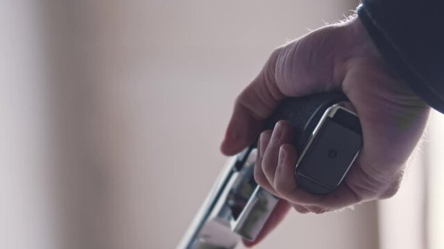 A man holding steel gun in his hand