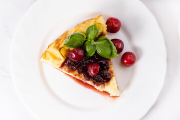 Piece of cottage cheese casserole with cherry jam. Piece of cheesecake