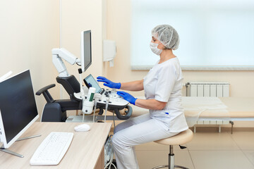 doctor at work on ultrasound equipment in hospital