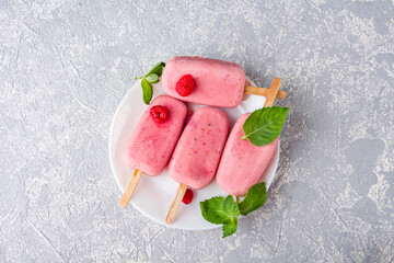 Homemade cooking vegan raspberries and coconut milk popsicles. Natural fruit and berry pink ice...