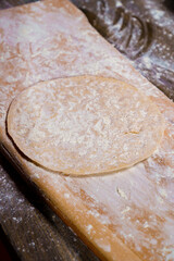 roll the dough into a thin tortilla on a cutting board. 