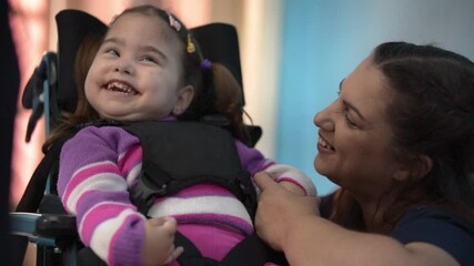mother talking to baby with disability  at home