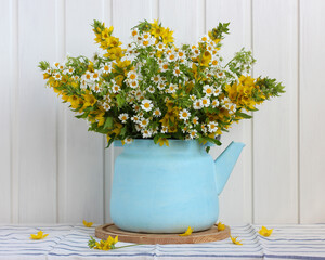 garden bouquet of  flowers in a blue teapot