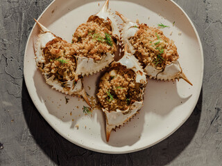 Close up of stuffed blue crabs on white plate