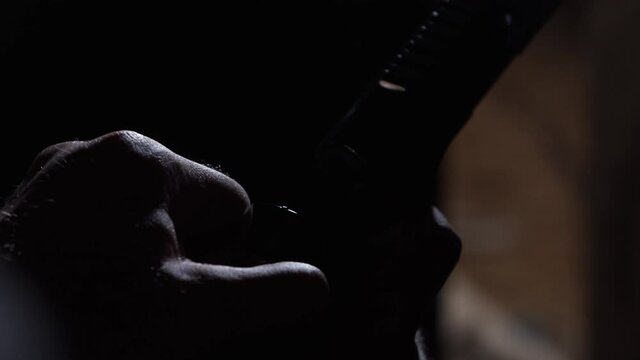 Badass man pulls the shutter of his gun