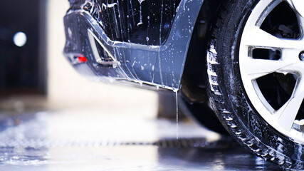 A view of a soapy windshield from inside of a car at the carwash