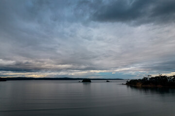 Rain clouds and aerial reverse sunset seascape at Corrigans Beach