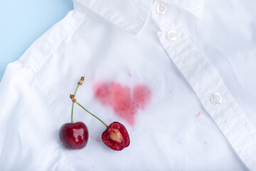 close up cherry stains from clothes. isolated on blue background