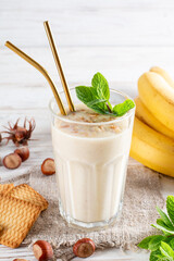 Healthy breakfast. Banana smoothie with cookies in a glass, fruits and cookies made of sunflower seeds, sesame and honey