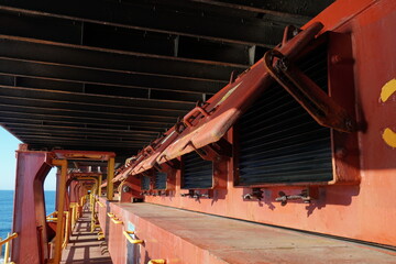 Open ventilation covers in a row of the side of the hatch covers installed on container vessel....
