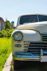 view of a beautiful old classic car, headlight, radiator grille, bumper, chrome