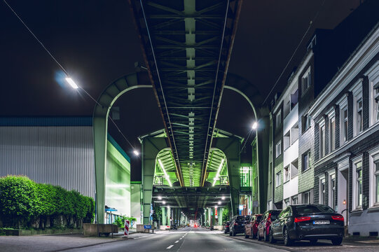 Night illuminated street with Schwebebahn stretching along in Wuppertal, Germany