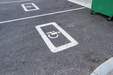 Parking space with a wheelchair symbol on the asphalt