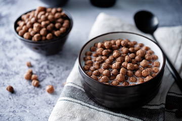 Fresh breakfast with chocolate balls with milk in a bowl