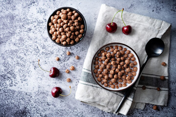 Fresh breakfast with chocolate balls with milk in a bowl