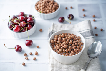 Fresh breakfast with chocolate balls with milk in a bowl