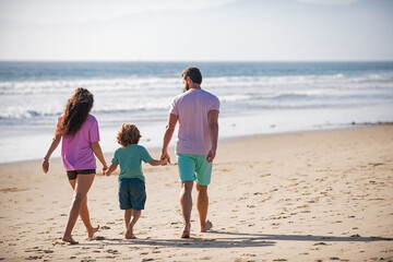 Family walking to the beach on a sunny day.