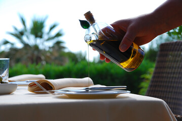 Hand serving pepper and extra virgin olive oil