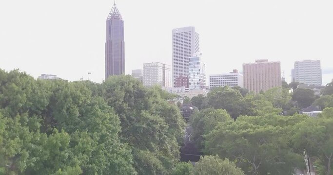 Drone Ascending Through Trees Revealing Downtown Atlanta