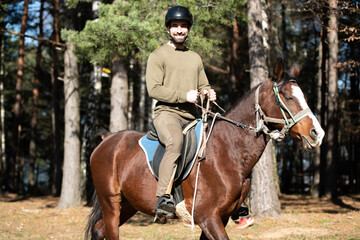 Young Man Wearing Helmet and Riding Horse