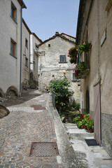 Fototapeta na wymiar A small street between the old houses of Poggio del Sannio, a medieval village in the Molise region.