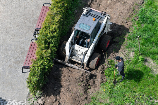 Top View Of A Skid Loader Working On Pathway Construction