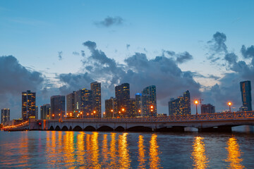 Miami city. Miami skyline panorama at dusk with skyscrapers over sea. Night downtown sanset.