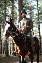 Foto op Canvas Riding Man Is Training His Horse © Jale Ibrak